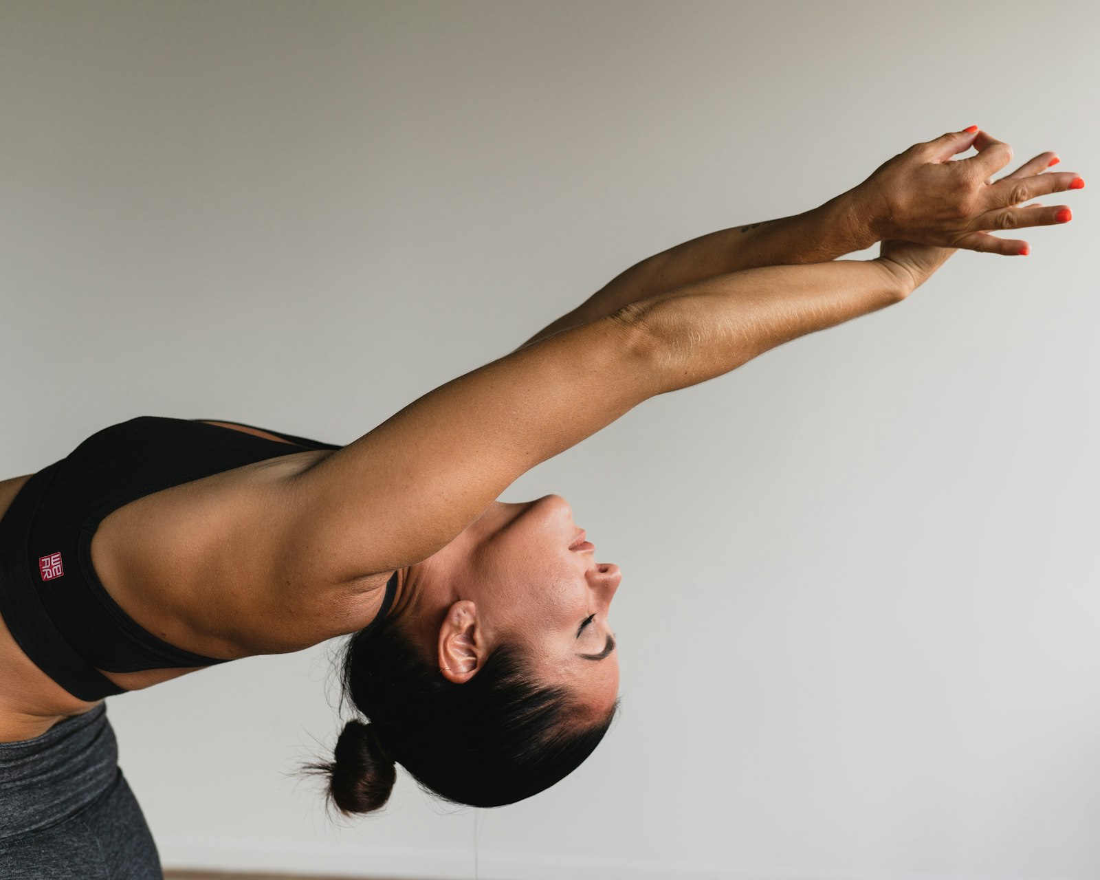 A woman arching back with arms raised