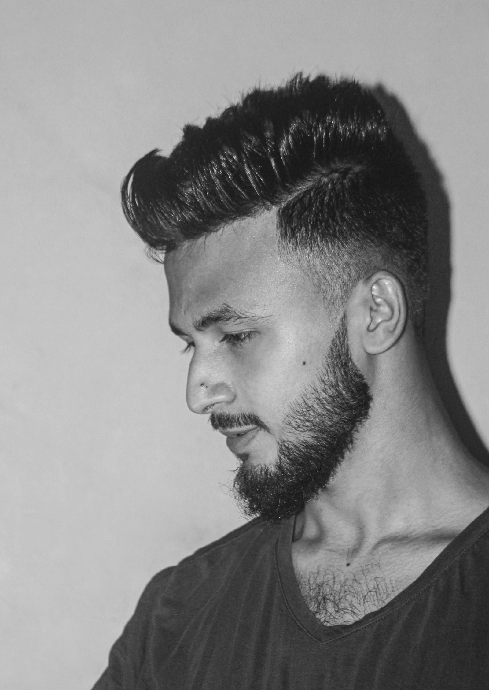 Slick back with full beard in profile